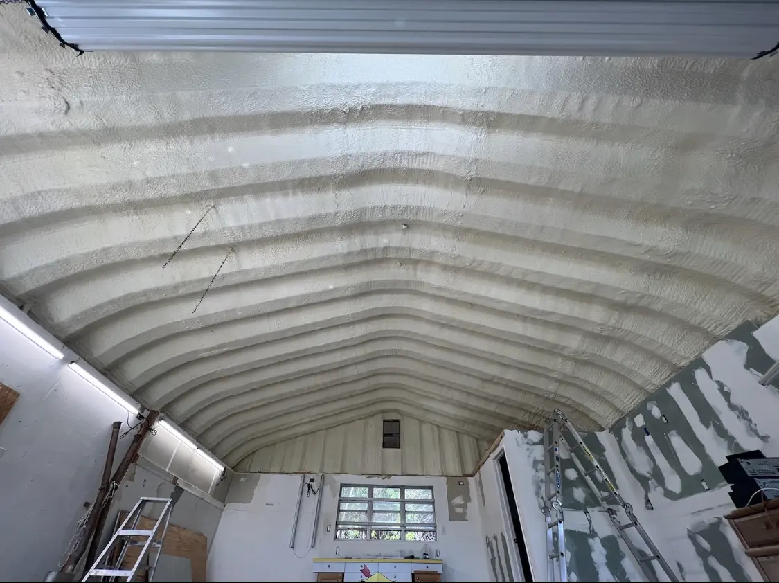 Spray polyurethane foam applied to the underside of a metal roof deck in Gering